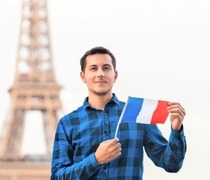 smiling-young-man-holding-french smiling-young-man-holding-french